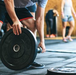 Focused weightlifting session in a gym with diverse athletes participating indoors. — Improve Posture Naturally with the Help