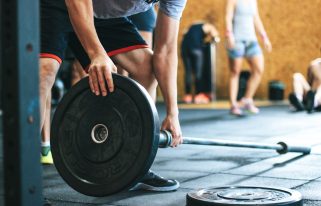 Focused weightlifting session in a gym with diverse athletes participating indoors. — Improve Posture Naturally with the Help